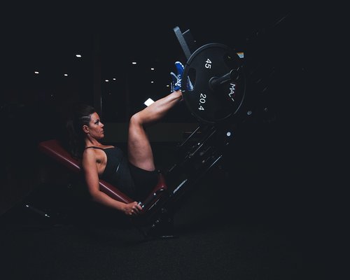 Athletes performing high intensity interval training in dark gym